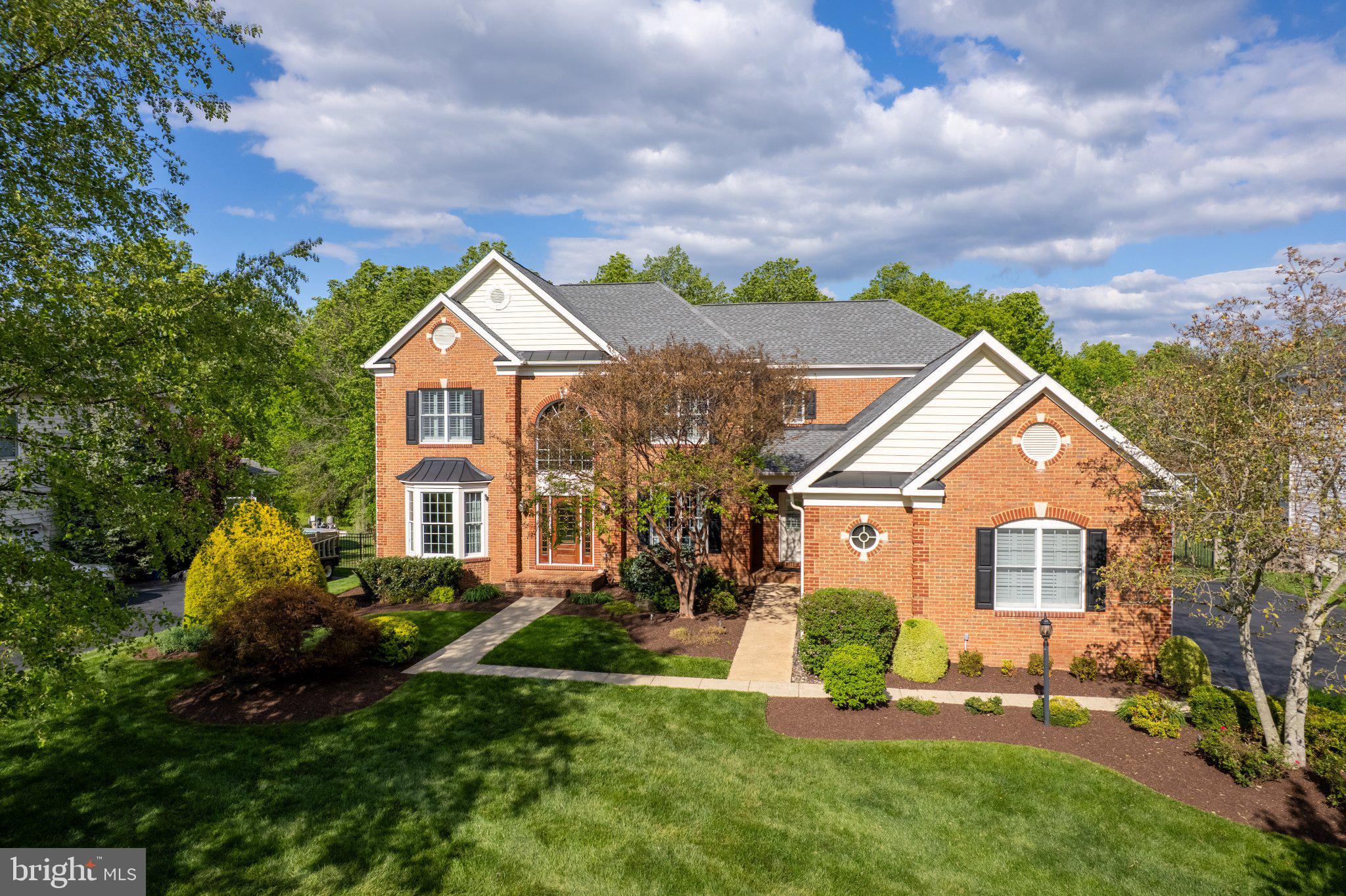 25554 Mimosa Tree Court Chantilly, VA 20152 - Photo 77 of 85 a front view of a house with a garden and plants