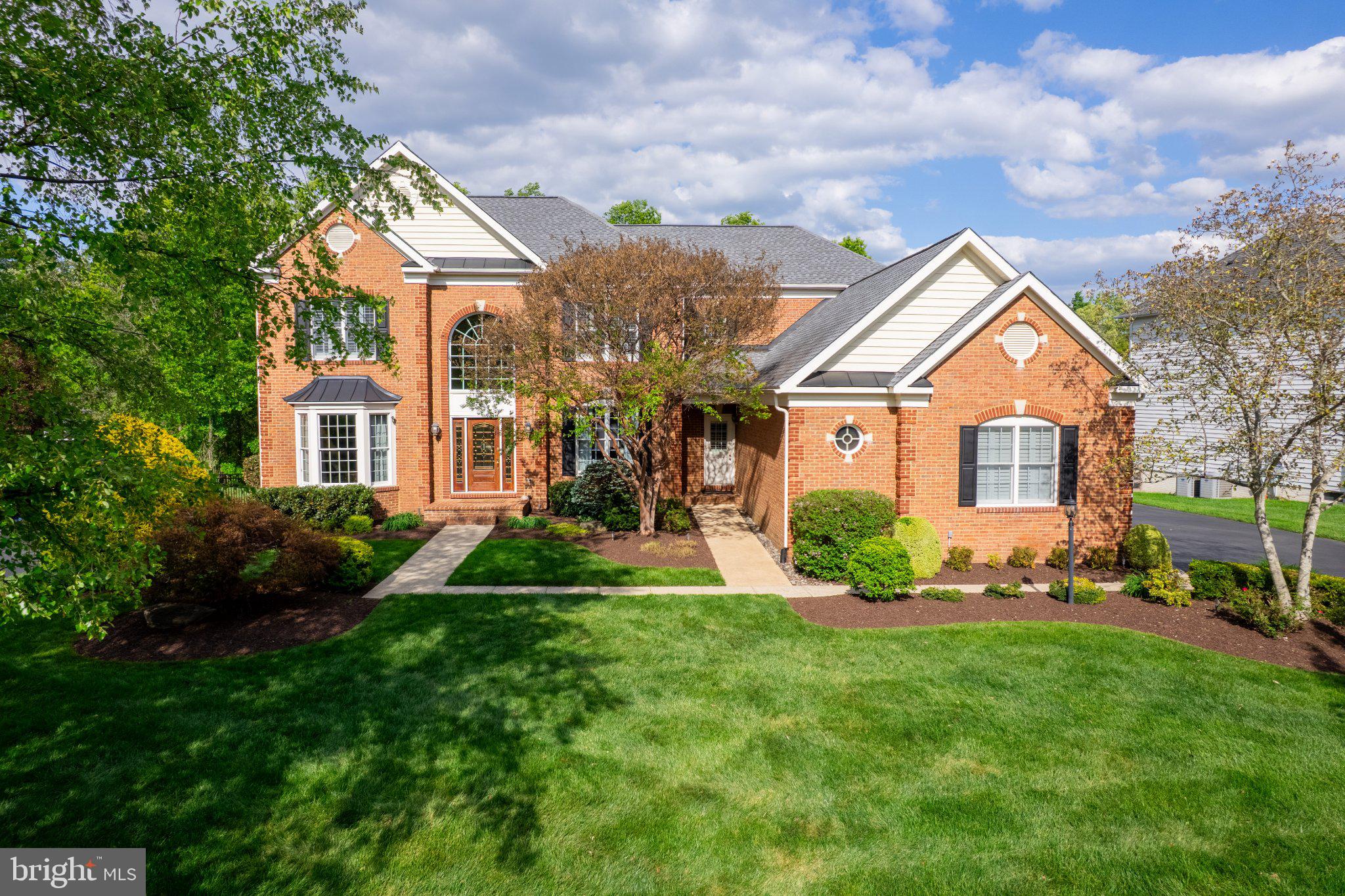 25554 Mimosa Tree Court Chantilly, VA 20152 - Photo 84 of 85 a front view of a house with a yard and garage