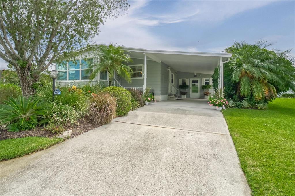 8304 Princess Court Palmetto, FL 34221 - Photo 1 of 1 front view of a house with a garden