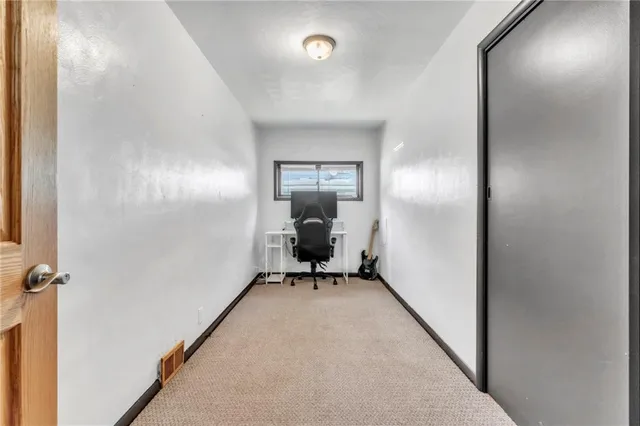 a view of a room with wooden floor cabinet and a bathroom