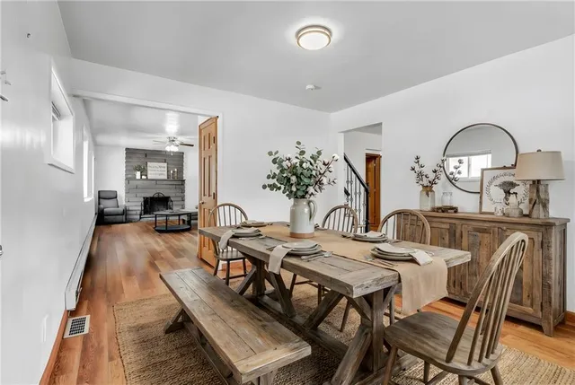 a view of a dining room with furniture and wooden floor