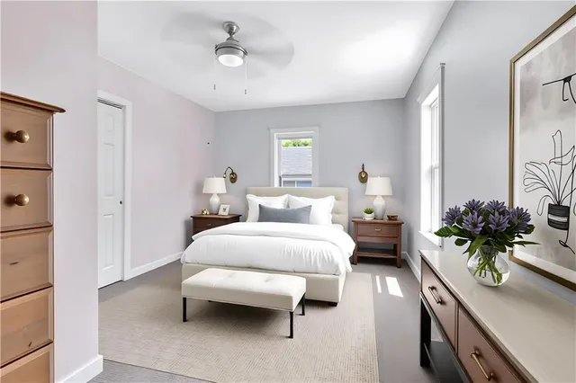 a bedroom with bed and a potted plant