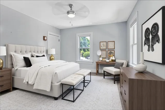 a spacious bedroom with a bed couch and a window