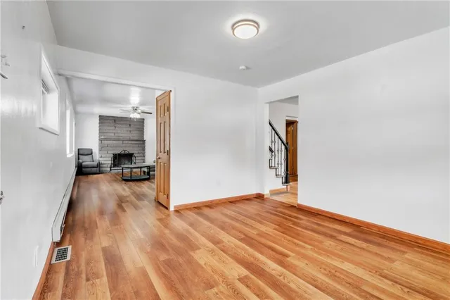 a view of a room with wooden floor and a chandelier