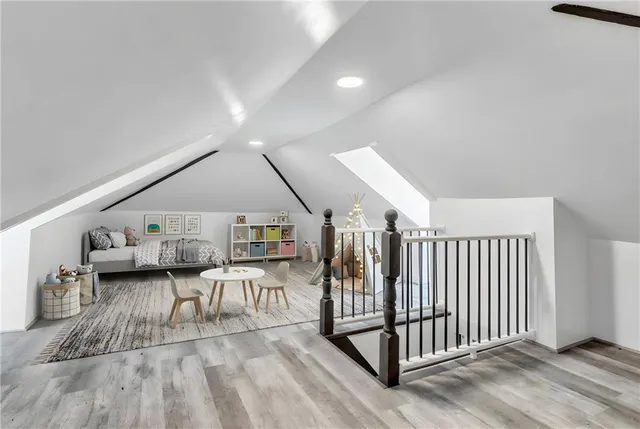 a living room with a white couches and white cabinets next to a window