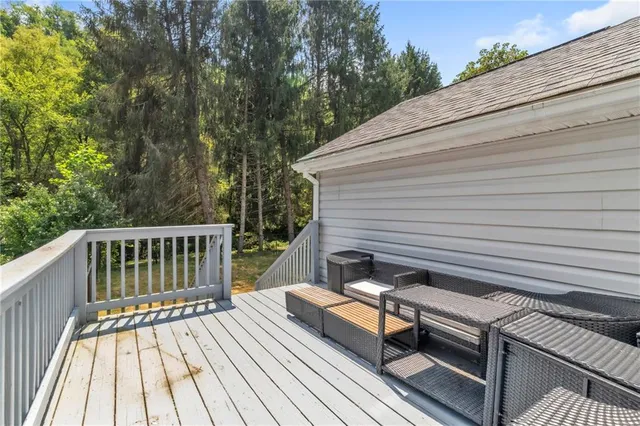 a view of backyard with a deck and wooden floor