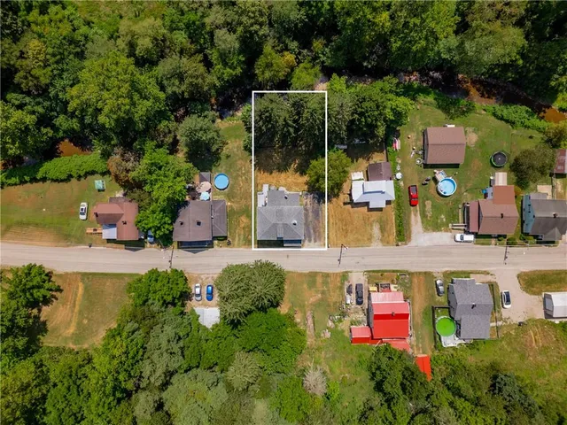 an aerial view of residential house with outdoor space and swimming pool