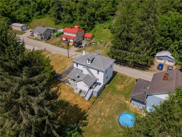 an aerial view of a house with outdoor space