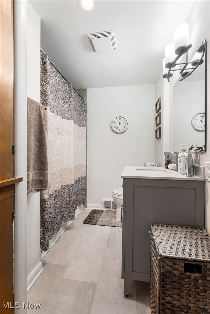 4727 15th Street Northwest Canton, OH 44708 - Photo 20 of 37 Full bath featuring a shower with shower curtain, vanity, and light tile patterned floors