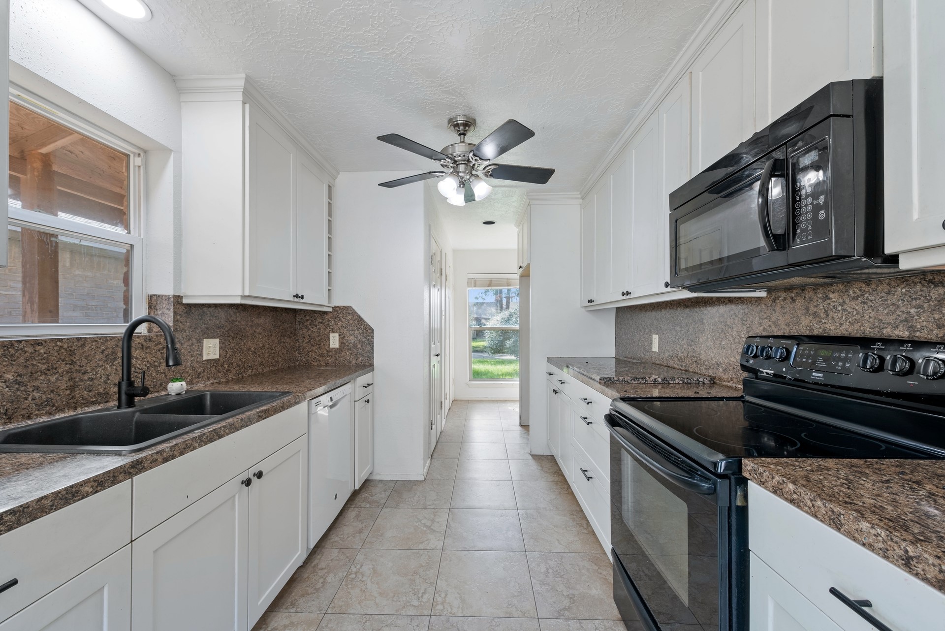 9622 Birsay Street Spring, TX 77379 - Photo 8 of 17 Kitchen boasts gleaming white cabinets and lots of counter space for cooking. Check out the customized storage in the kitchen.