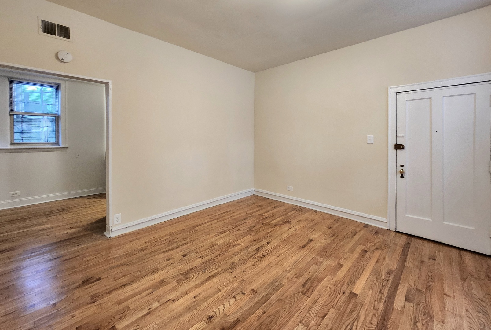 3746 West Irving Park Road, Unit GDN Chicago, IL 60618 - Photo 3 of 11 wooden floor in an empty room