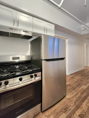 a stove top oven sitting inside of a kitchen