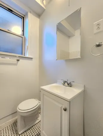 a bathroom with a sink a toilet and mirror