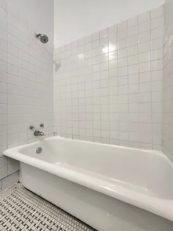 a bathroom with a bathtub and shower