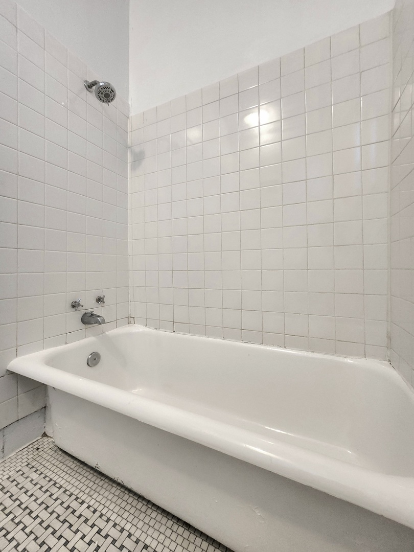 3746 West Irving Park Road, Unit GDN Chicago, IL 60618 - Photo 9 of 11 a bathroom with a bathtub and shower