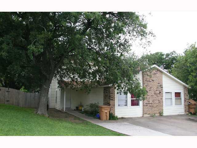 Obstructed view of property with brick siding