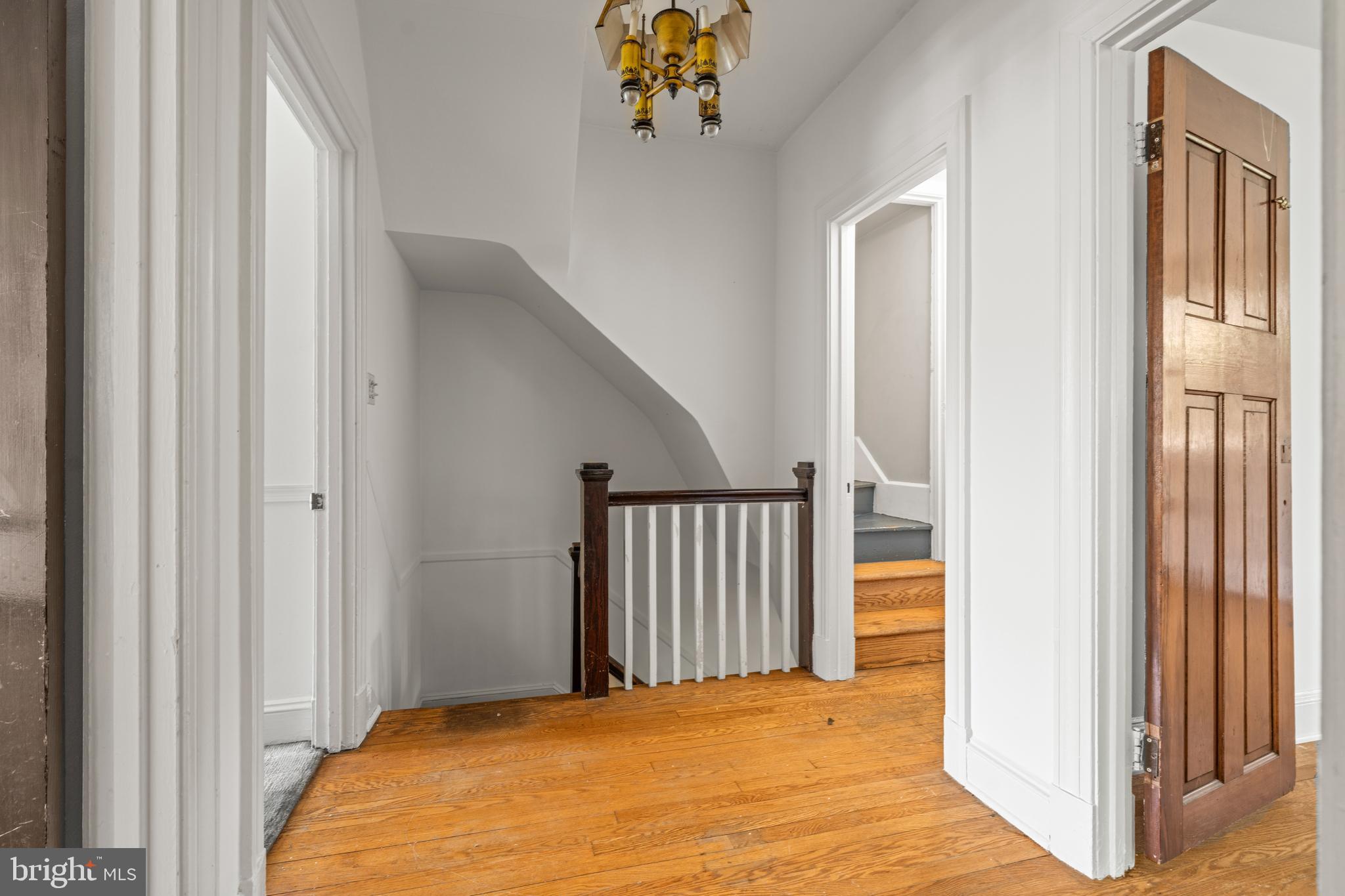 309 Hopkins Road Baltimore, MD 21212 - Photo 15 of 36 a view of a hallway with wooden floor and stairs