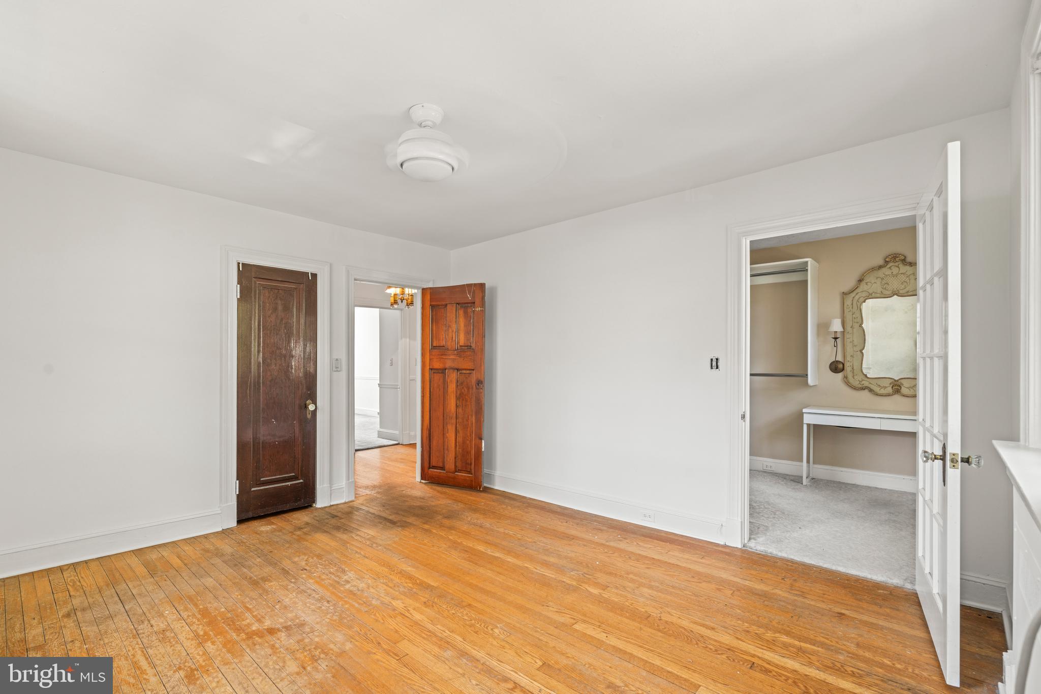 309 Hopkins Road Baltimore, MD 21212 - Photo 17 of 36 a bedroom with a bed and wooden floor