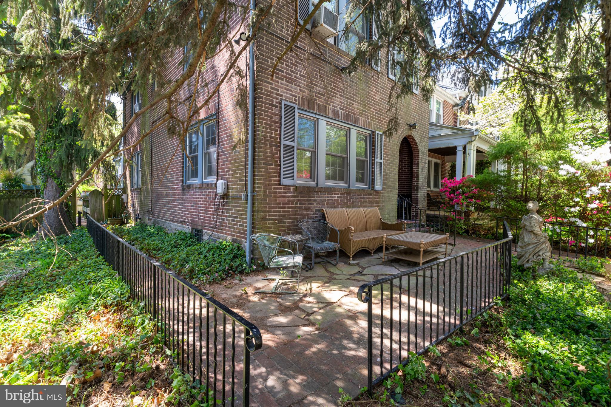 309 Hopkins Road Baltimore, MD 21212 - Photo 2 of 36 a view of house with patio outdoor seating and covered with trees