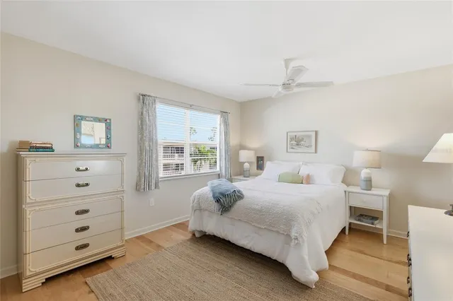 a bedroom with a bed a rug and a large window