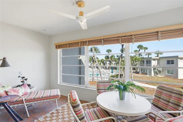 a dining room with furniture and a potted plant