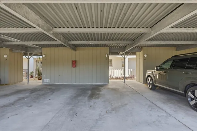 a view of a hallway with furniture and a window