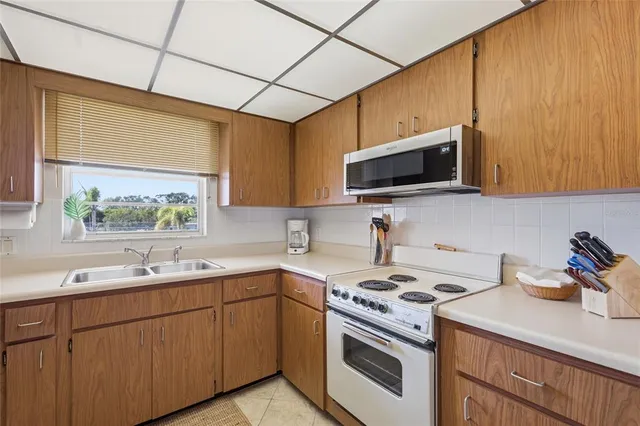 a kitchen with a sink stove and microwave