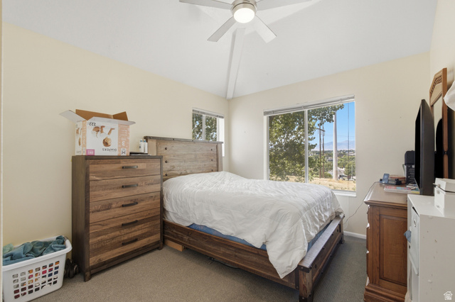 5788 Walden Ridge Drive Murray, UT 84123 - Photo 23 of 29 This bedroom offers vaulted ceilings, soft carpet flooring, and a ceiling fan with integrated lighting