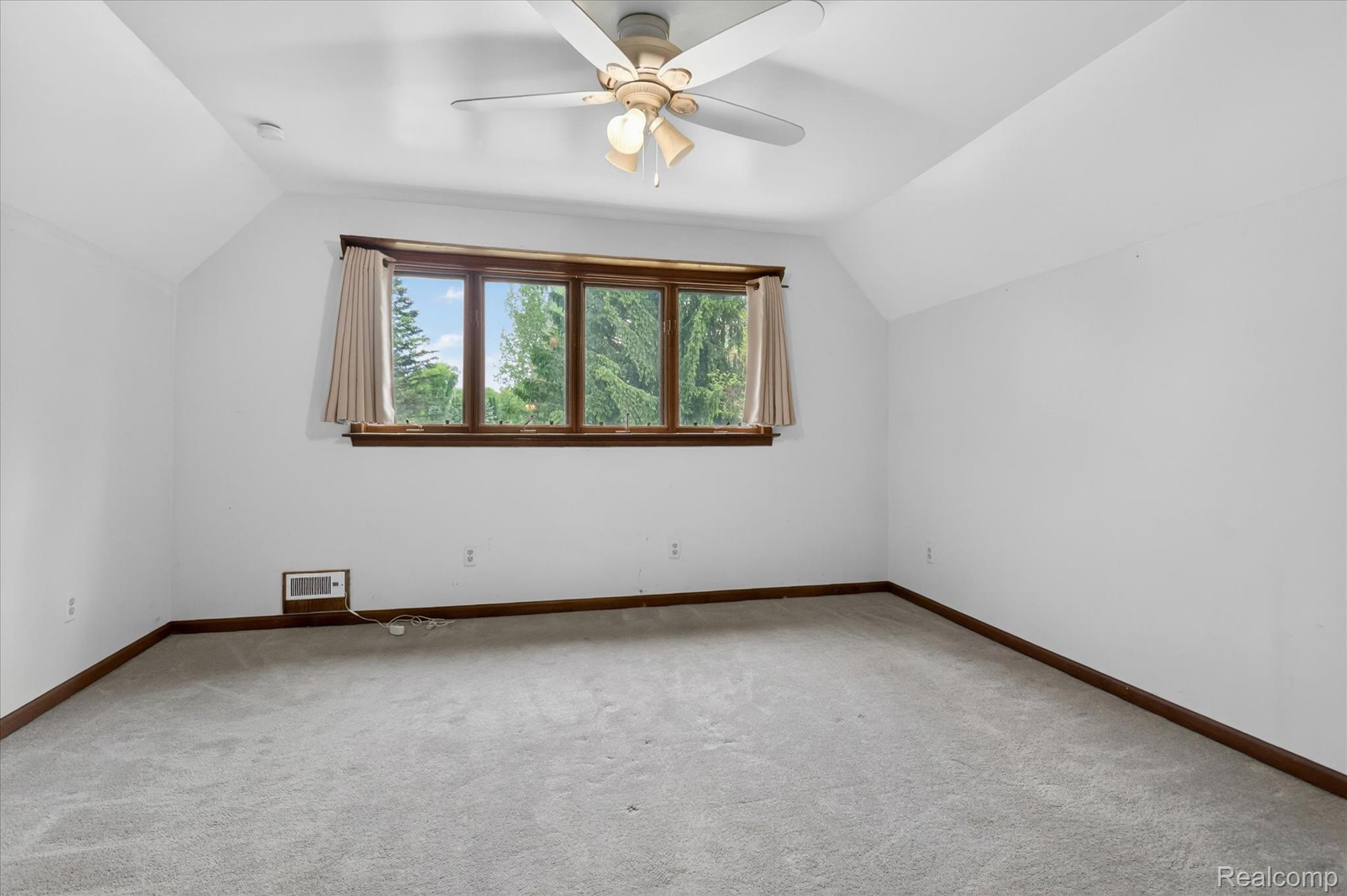 41303 Harris Road Belleville, MI 48111 - Photo 31 of 49 Bonus room featuring vaulted ceiling, a ceiling fan, and light carpet