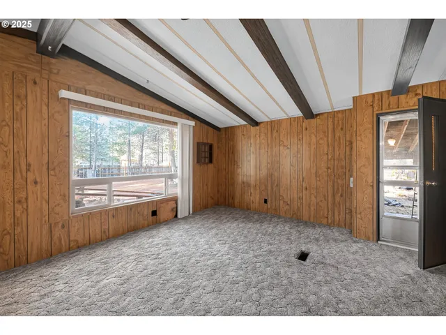 a view of an empty room and a window