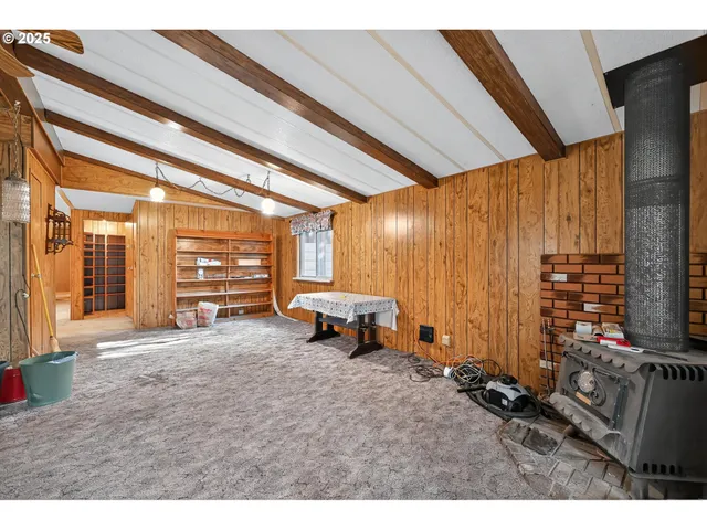 a view of a livingroom with wooden floor and windows