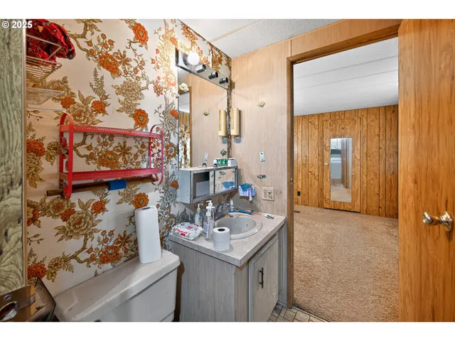 a kitchen with stainless steel appliances granite countertop a stove a sink dishwasher and a dining table with wooden cabinet