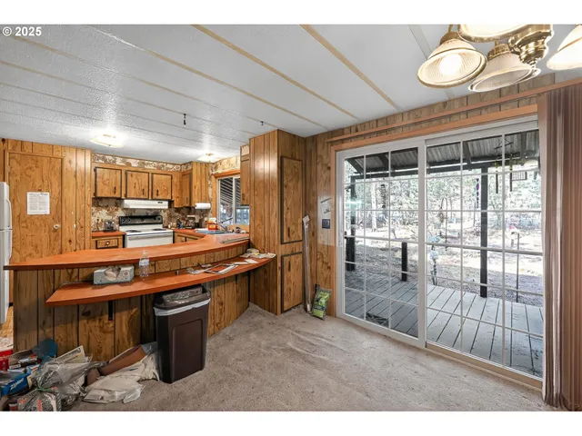 a kitchen with stainless steel appliances kitchen island granite countertop a refrigerator a stove top oven a sink and dishwasher