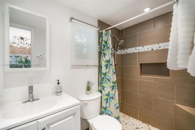 a bathroom with a sink toilet and shower