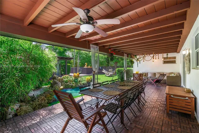 a view of a chairs and table in patio with wooden fence