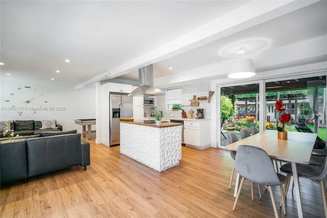 a living room with furniture and a kitchen
