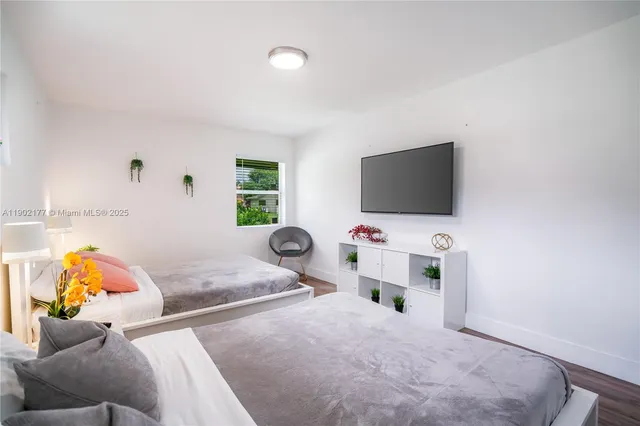 a bedroom with furniture and a flat screen tv