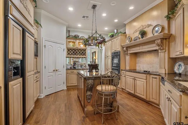 a kitchen with refrigerator cabinets dining table and chairs