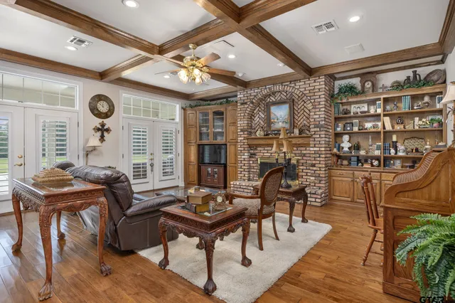 a living room with furniture a rug and a large window