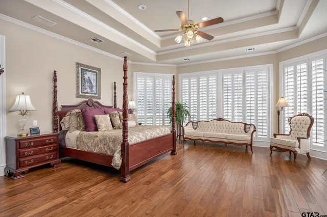 a bedroom with a bed and a chandelier