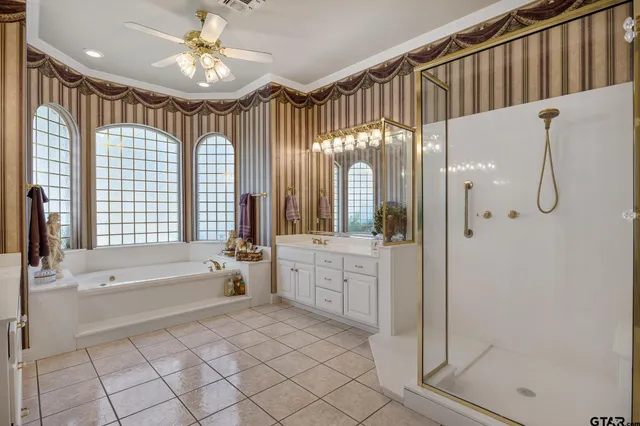 a spacious bathroom with a shower a mirror and a bathtub