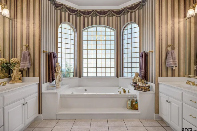 a bathroom with a bathtub sink and mirror