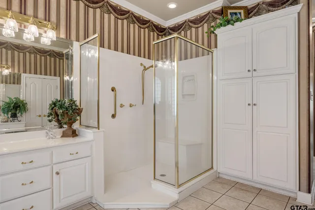a bathroom with a shower and a sink a mirror
