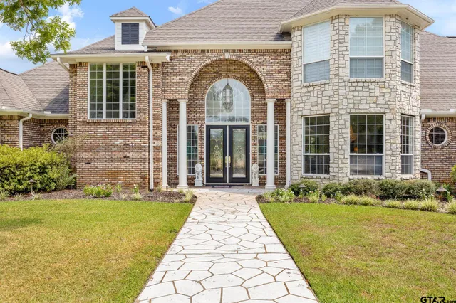 a view of a brick house with a large windows