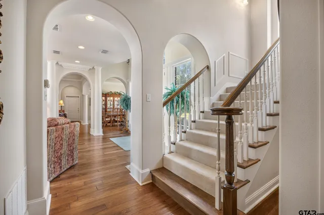 a view of entryway and hall with wooden floor