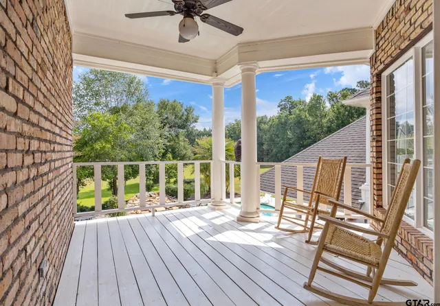 a view of balcony with wooden floor and fence
