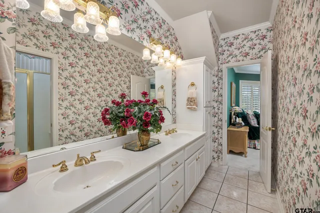 a bathroom with a sink and mirror with shower