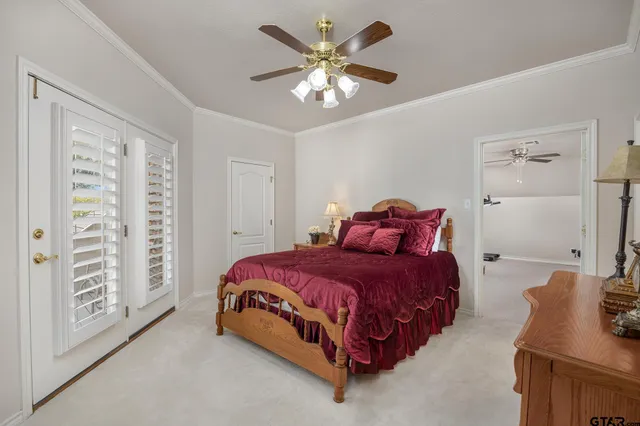 a spacious bedroom with a bed and a chandelier