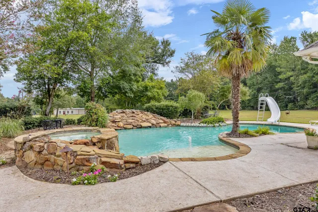 a view of a swimming pool with a patio