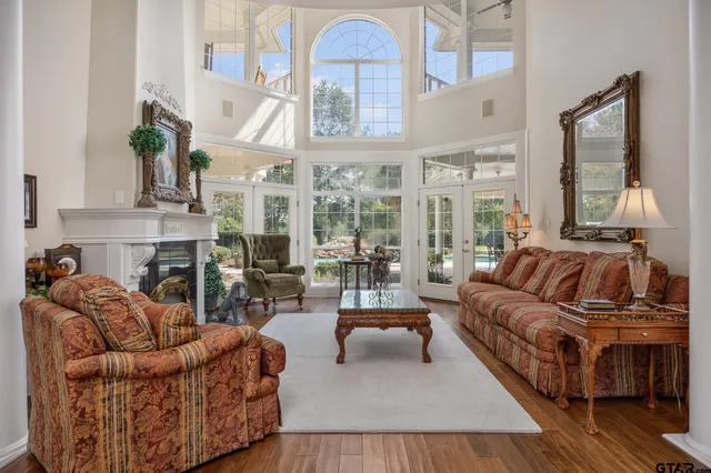 a living room with furniture fireplace and a large window